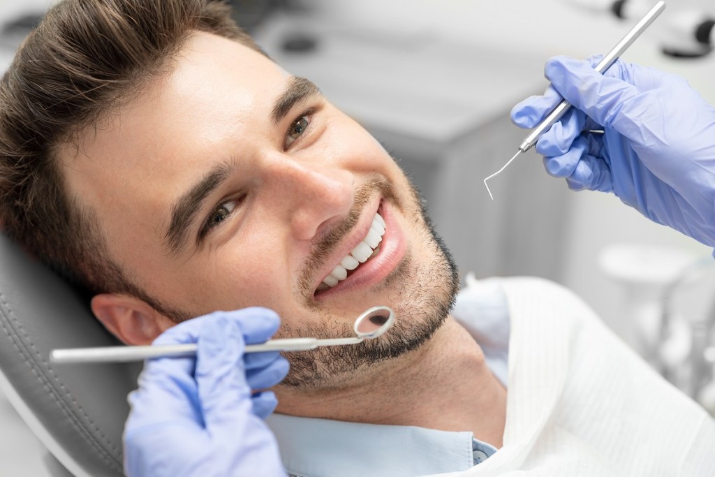 smiling man in dental chair