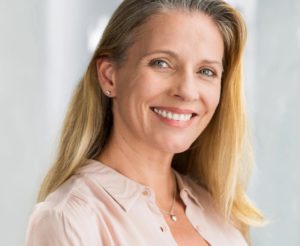 a smiling older woman with perfect teeth